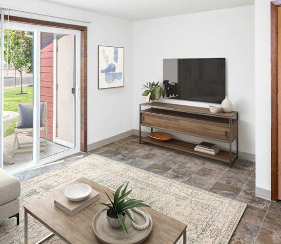 a living room with white walls and a sliding glass door