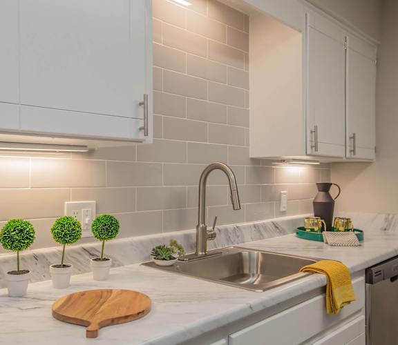 a kitchen with white cabinets and a sink at The Dylan, Murfreesboro, TN