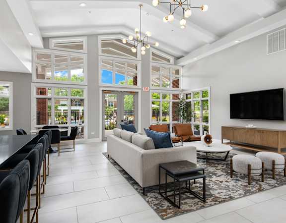 A modern living room with a large couch and a television.
