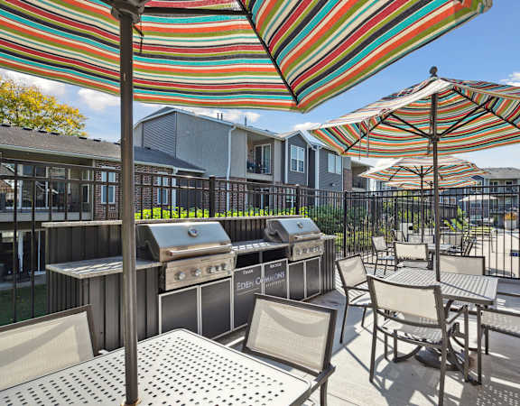 A patio with striped umbrellas and chairs.