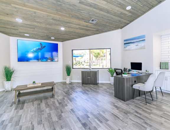 A modern clubhouse with a wooden ceiling and grey flooring. at Tides on McDowell, Arizona, 85035