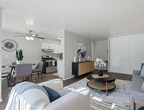 A modern living room with a grey sofa and a coffee table.