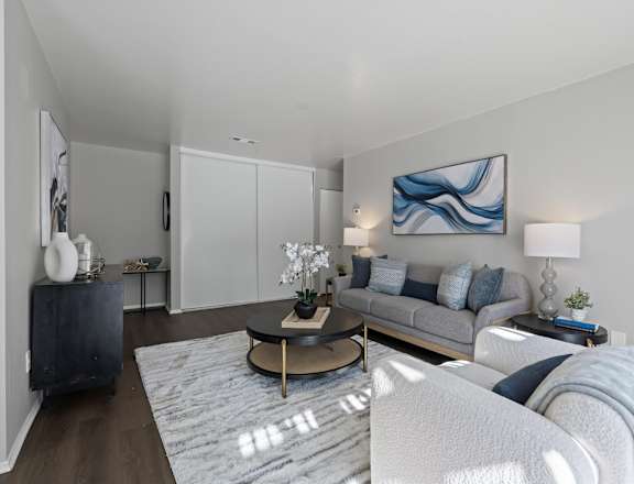 A modern living room with a grey sofa and a coffee table.
