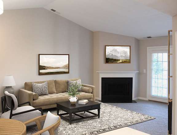 A living room with a fireplace and a painting on the wall.