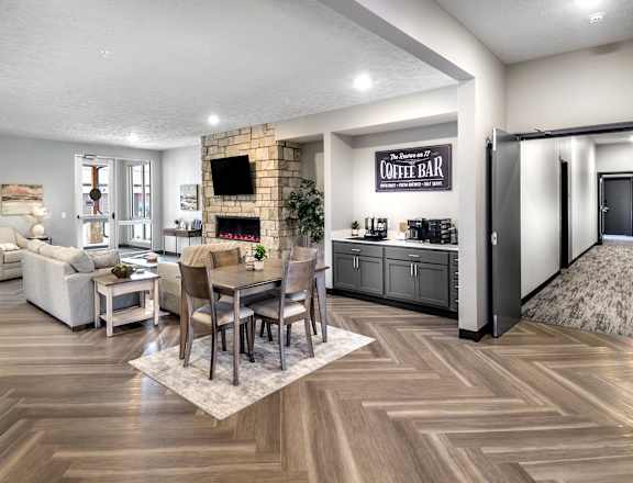 A modern living room with a coffee bar and a fireplace.