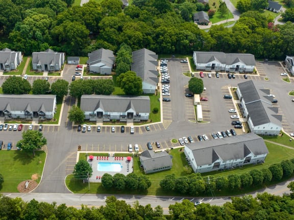 an aerial view of a parking lot with several buildings and a pool at The Dylan, Murfreesboro, TN 37129