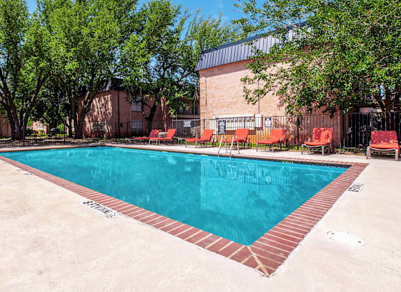 A rectangular pool with a red border and a brownish floor.