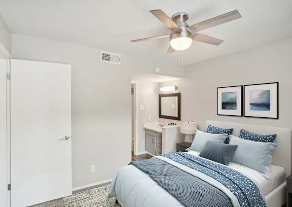 a bedroom with a bed and a ceiling fan at The Keller, Texas