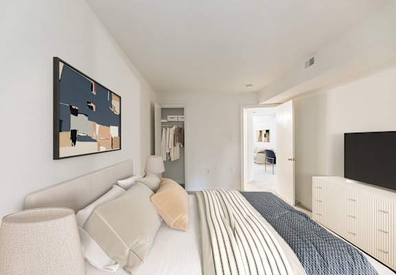 A bedroom with a bed, a lamp, and a painting on the wall at The Fields of Rockville, Maryland