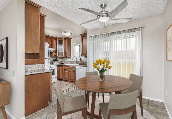 a kitchen with a ceiling fan and a table with chairs  at Pacific Sands, California, 92117