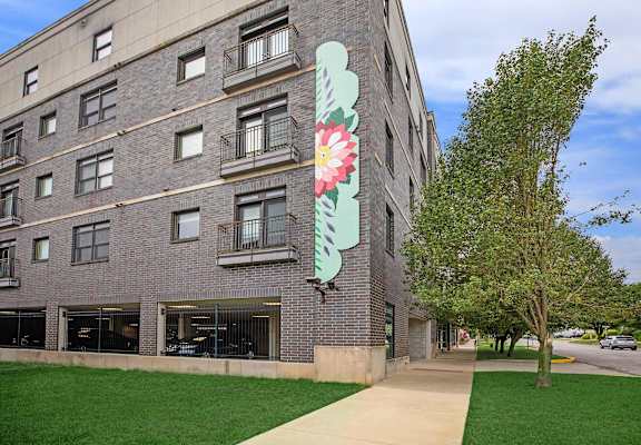 A large building with a large flower painted on the side.