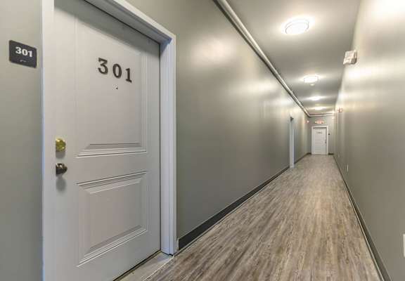 A hallway with a door numbered 301 at the end.