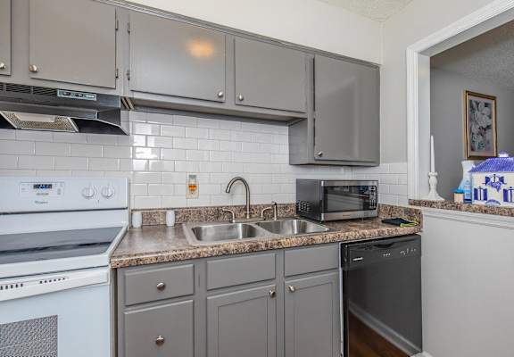 a kitchen with stainless steel appliances and granite counter tops