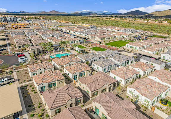an aerial view of a neighborhood of houses and cars
