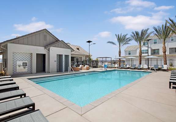 take a dip in the resort style pool with lounge chairs at Solstice at Fiddyment Ranch, California