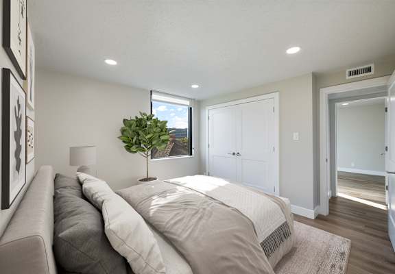 A bedroom with a large bed and a couch.