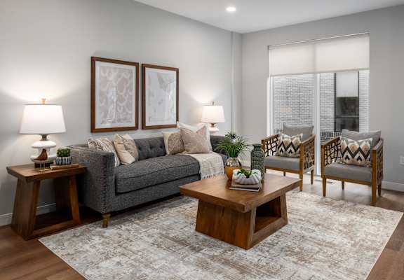 a living room with a couch and a coffee table at The Flats & Terraces at Wildhorse Village, Chesterfield Missouri