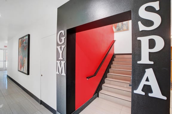 the stairway in the lobby of a building with a red door at Evoq Apartment Homes, Las Vegas, 89169