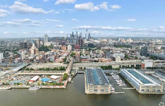 A cityscape with a large body of water in the foreground and a skyline in the background.