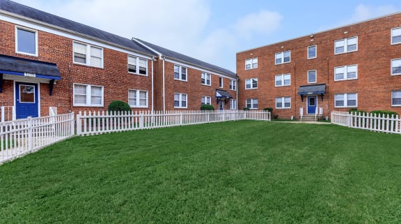 a large green lawn in front of a brick building at Highland Ridge, Capitol Heights, 20743