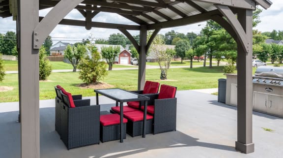 a patio with a table and chairs under a gazebo at The Dylan, Murfreesboro, TN 37129