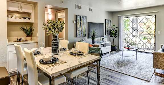 A dining room with a table set for four.