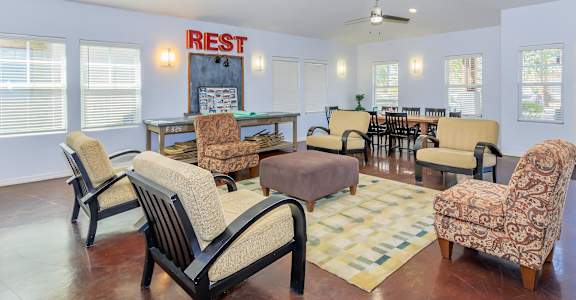 a living room with furniture and a table and chairs
