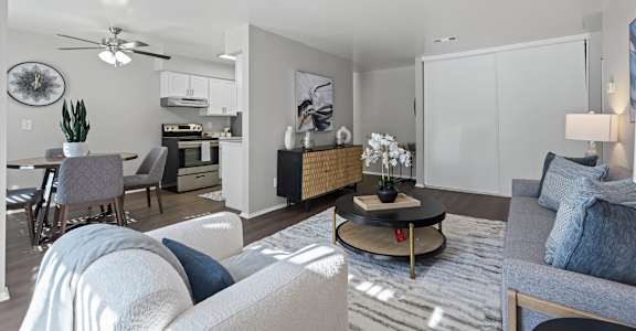 A modern living room with a grey sofa and a coffee table.