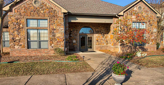 A house with a stone facade and a tower.