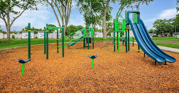 A playground with a green slide and a blue slide at Poplar Place Apartments, Springfield, 62703