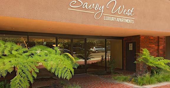 The front of a building with the number 7270 and the words "Savvy West Luxury Apartments" on it.
