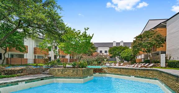 a swimming pool at an apartment building with a blue pool