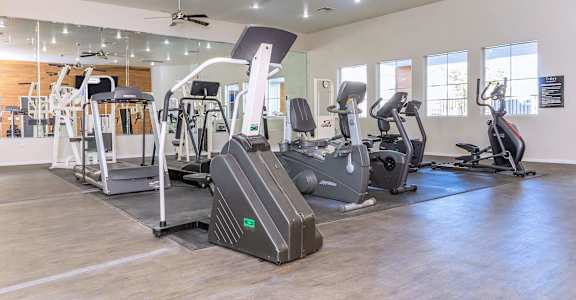 a gym with various exercise equipment in a building