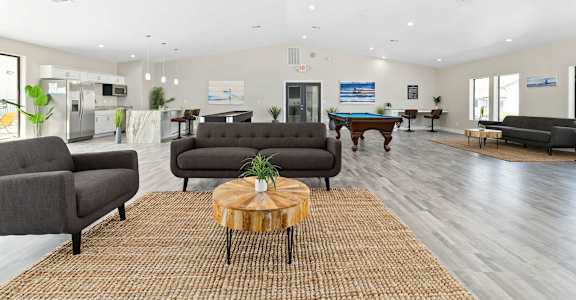 a living room with couches and a pool table