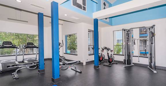 A gym with blue and white walls and equipment.at The Keller, San Antonio, TX 78230