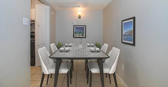 a dining room with a table and chairs