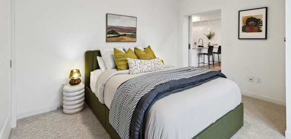 a bedroom with a large bed and white walls