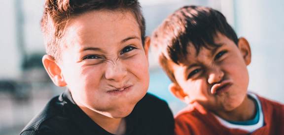 Two young boys making funny faces at the camera at Coast Pine