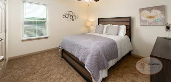 a bedroom with a bed and a ceiling fan