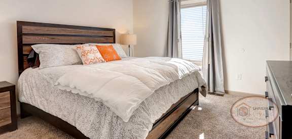 a bedroom with a bed and a ceiling fan
