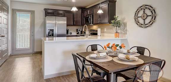 an open kitchen and dining room with a table and chairs
