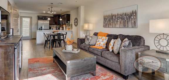a living room with a couch and a ceiling fan