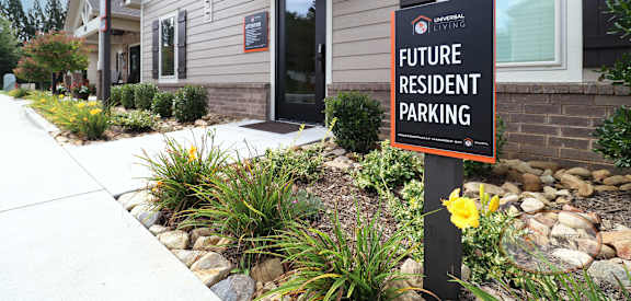 A sign in front of a building that says "Future Resident Parking".