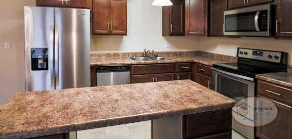 a kitchen with stainless steel appliances and a granite counter top