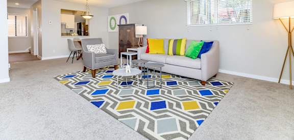 a living room with a couch and a rug