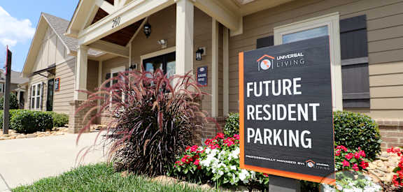 A sign in front of a building that says Future Resident Parking.