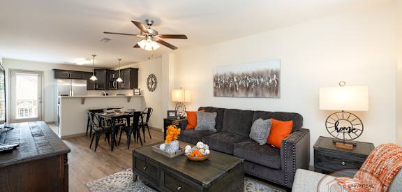A living room with a grey couch and a coffee table.
