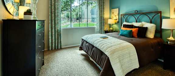 a bedroom with a large bed and a ceiling fan