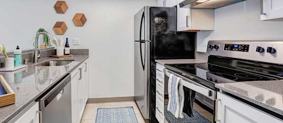 a kitchen with stainless steel appliances and granite counter tops