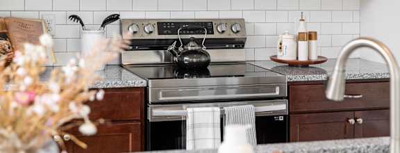 a kitchen with stainless steel appliances and marble counter tops